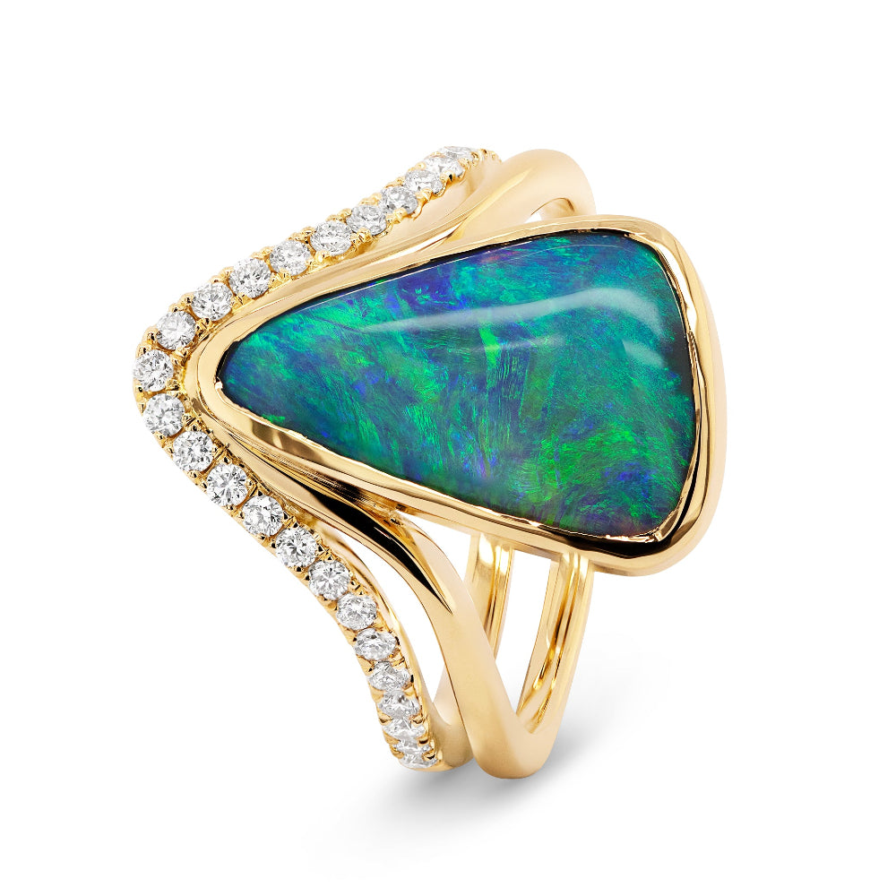 Gold ring with a large green opal stone and diamond accents on a white background