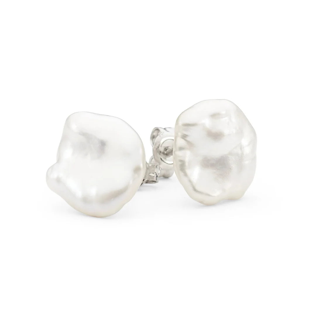 The Pebble Studs celebrate the natural beauty of Keshi pearls, with each pair offering its own organic shape and subtle lustre. No two are ever the same, giving you a distinctive look that feels beautifully individual. Their petite size makes them effortless for everyday wear, while the choice of gold or silver adds versatility for any style.