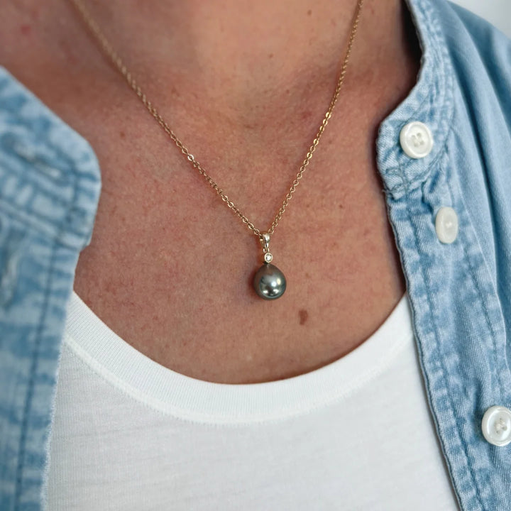Elevate your jewellery collection with the Marion Tahitian Pendant, a timeless symbol of sophistication. Featuring a striking drop-shaped Tahitian pearl, each piece showcases a rich, luminous lustre with captivating iridescent overtones. Sourced from the pristine waters of French Polynesia, these naturally coloured pearls embody effortless elegance. Whether worn alone or layered, this pendant is a refined statement of luxury and style.