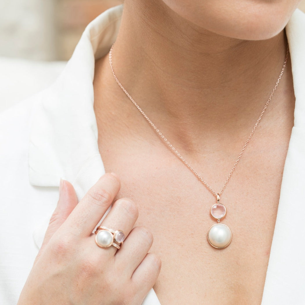 Softly luminous and effortlessly elegant, the Pink Moon Pendant features a creamy white Mabe cultured pearl, celebrated for its smooth, radiant glow. Suspended beneath, a delicate rose quartz drop adds a gentle blush of colour and feminine charm. Timeless yet versatile, this pendant is perfect for everyday wear or as a meaningful gift for someone special, with matching earrings available to complete the set.