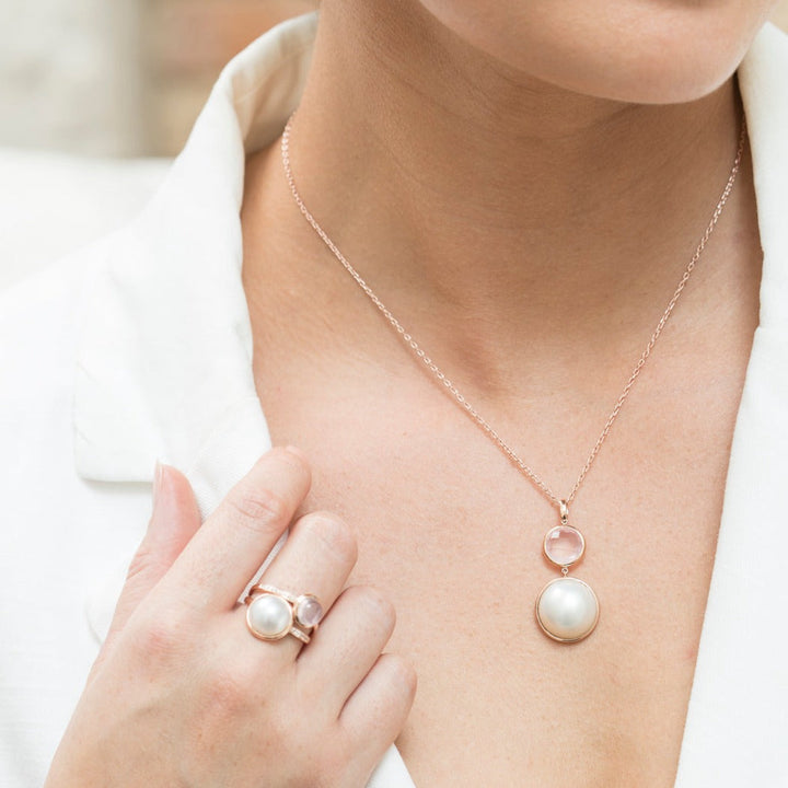Softly luminous and effortlessly elegant, the Pink Moon Pendant features a creamy white Mabe cultured pearl, celebrated for its smooth, radiant glow. Suspended beneath, a delicate rose quartz drop adds a gentle blush of colour and feminine charm. Timeless yet versatile, this pendant is perfect for everyday wear or as a meaningful gift for someone special, with matching earrings available to complete the set.