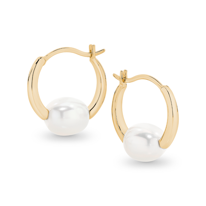 Elegant and versatile, the Freya Hoops feature lustrous oval freshwater pearls resting securely within the curve of the hoops. Their classic yet modern design makes them perfect for effortless, everyday style or elevating a special occasion look. Lightweight and timeless, these pearl hoops are a must-have staple for any jewellery collection.