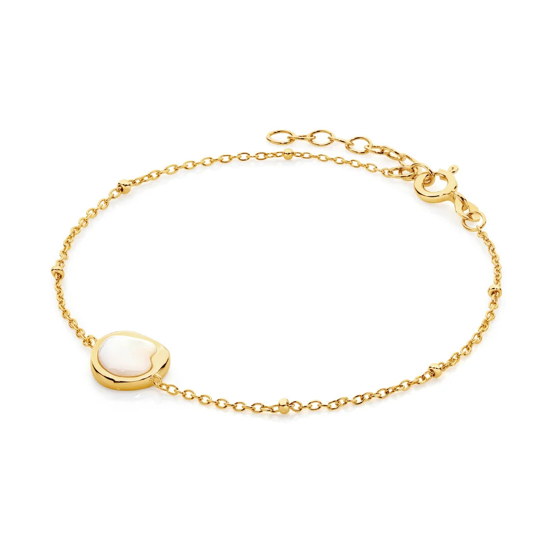 Refined and radiant, the Kiara Bracelet features a uniquely shaped white Mother of Pearl charm set in yellow gold-plated sterling silver. Designed on a delicate chain, this piece adds a soft, luminous touch to the wrist — perfect worn alone or layered with your everyday favourites.