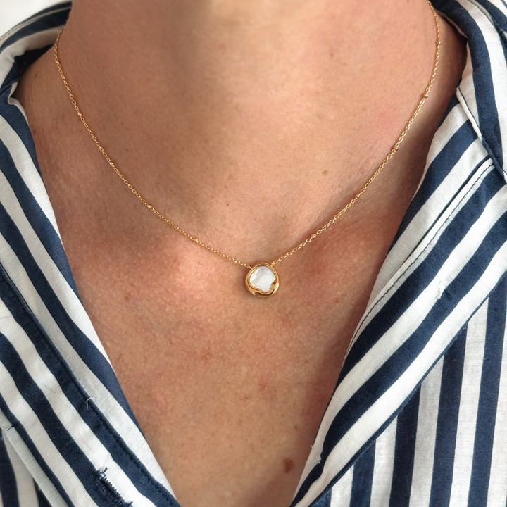 Elegant and effortless, the Kiara Necklace features a uniquely shaped white Mother of Pearl pendant set in yellow gold-plated sterling silver. Suspended on a chain, this piece brings a soft, luminous glow to any neckline — perfect for layering or wearing solo as a subtle statement.