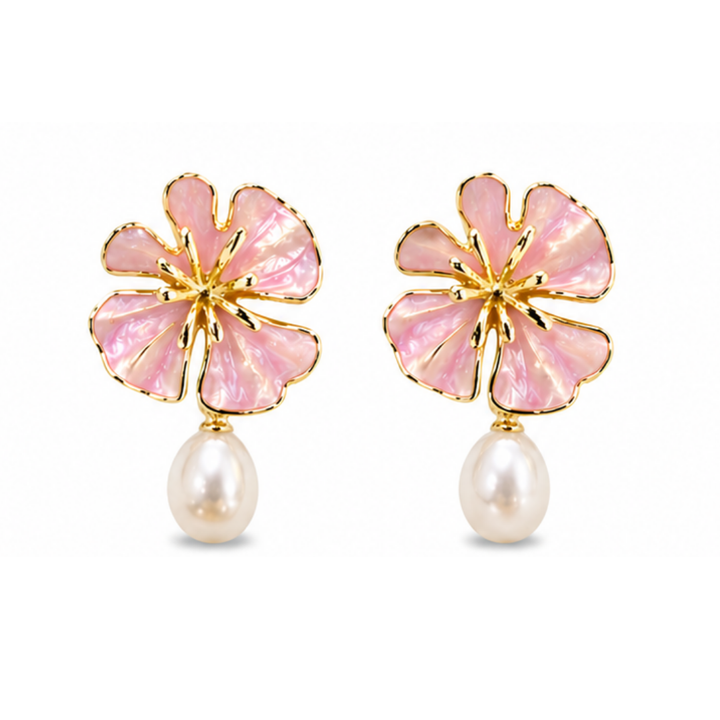 The Posie Earrings are a joyful expression of colour and craftsmanship, crafted in sterling silver with warm yellow gold plating and finished with delicate enamel petals in a soft blush or blue tone. Inspired by blooming florals, each earring is accented with a luminous white freshwater pearl that catches the light with a gentle, natural glow. The combination of soft colour, golden warmth, and organic form creates a look that feels both playful and refined, balancing timeless pearl elegance with a fresh, mo