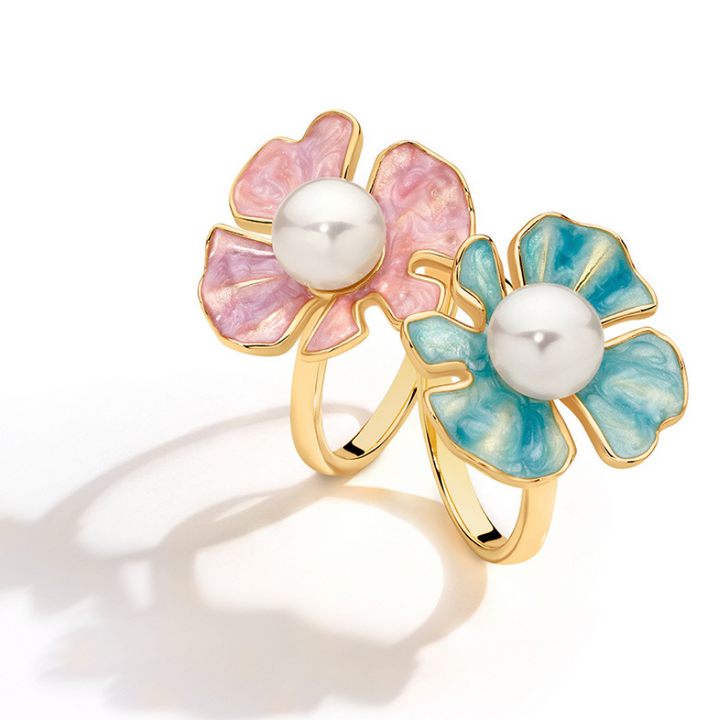 The Posie Ring is a joyful celebration of colour and craftsmanship, crafted in sterling silver with warm yellow gold plating and finished with delicate enamel petals. At its centre sits a luminous white button freshwater pearl, glowing softly against the vibrant enamel and golden tones. Inspired by blooming florals, this design feels playful yet refined, balancing timeless pearl elegance with a fresh, modern twist. 