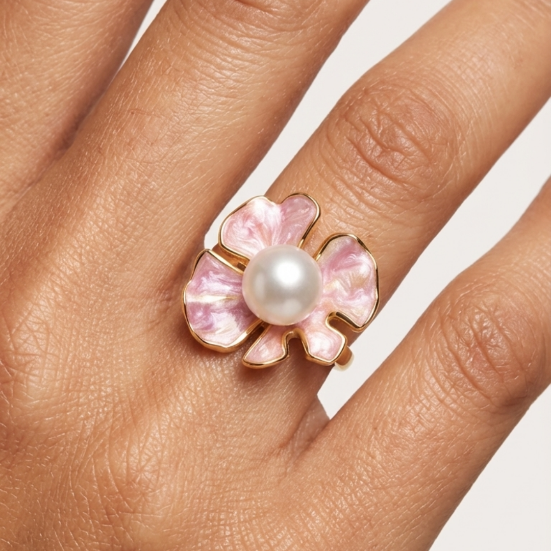 The Posie Ring is a joyful celebration of colour and craftsmanship, crafted in sterling silver with warm yellow gold plating and finished with delicate enamel petals. At its centre sits a luminous white button freshwater pearl, glowing softly against the vibrant enamel and golden tones. Inspired by blooming florals, this design feels playful yet refined, balancing timeless pearl elegance with a fresh, modern twist. 