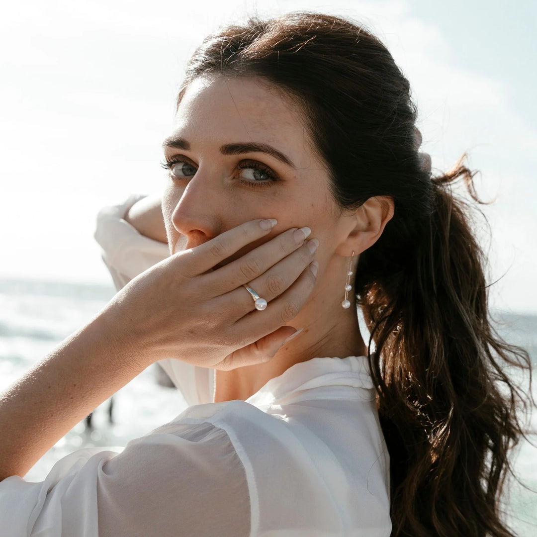 Introducing a captivating blend of sophistication and grace: the Ethereal Pearl Earrings. Imbued with timeless charm, these exquisite earrings are a testament to refined elegance, making a striking statement for those who appreciate the finer things in life.