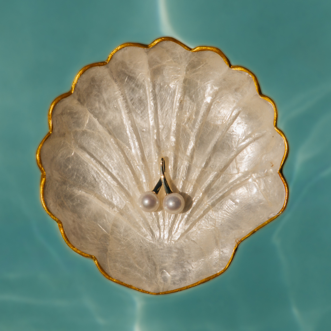 A statement in refined elegance, the Juniper Pendant features two luminous Edison freshwater pearls, beautifully set in 9ct yellow gold. With its double-drop design and radiant finish, this pendant is a timeless expression of sophistication — perfect for marking a special occasion or elevating everyday wear.