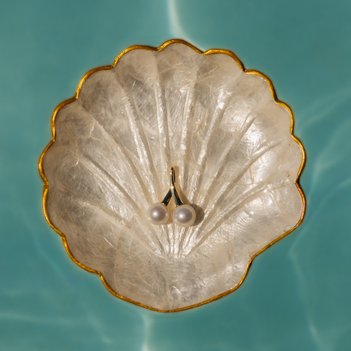 A statement in refined elegance, the Juniper Pendant features two luminous Edison freshwater pearls, beautifully set in 9ct yellow gold. With its double-drop design and radiant finish, this pendant is a timeless expression of sophistication — perfect for marking a special occasion or elevating everyday wear.
