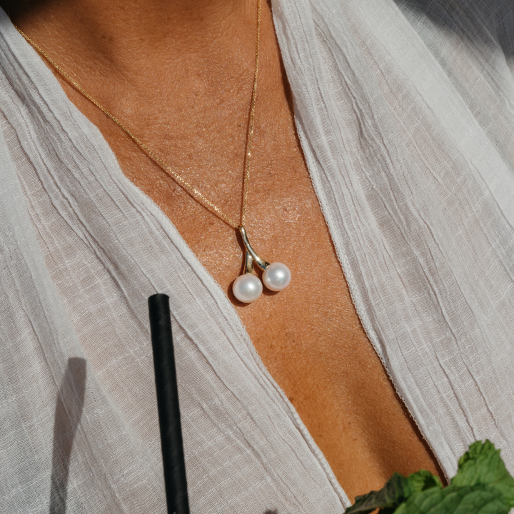 A statement in refined elegance, the Juniper Pendant features two luminous Edison freshwater pearls, beautifully set in 9ct yellow gold. With its double-drop design and radiant finish, this pendant is a timeless expression of sophistication — perfect for marking a special occasion or elevating everyday wear.