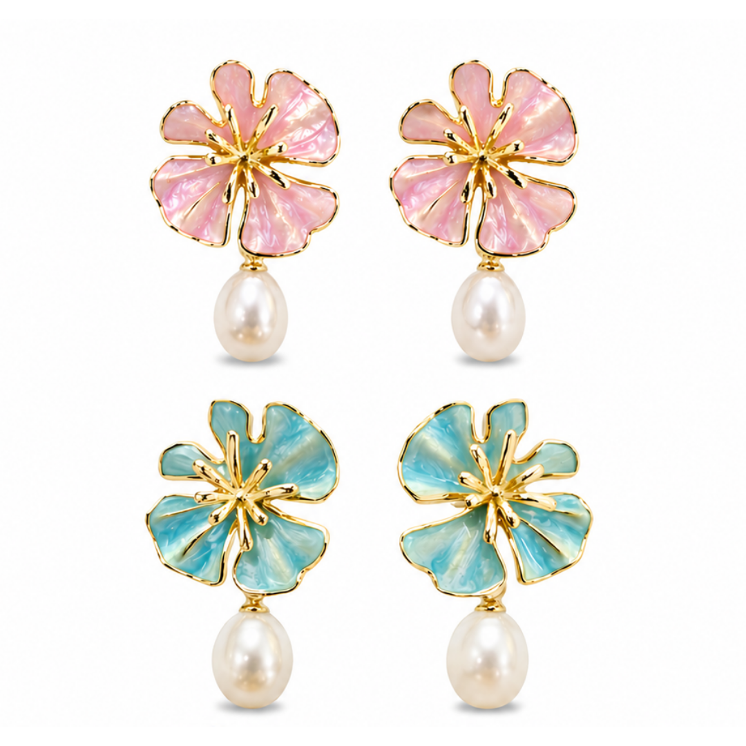 The Posie Earrings are a joyful expression of colour and craftsmanship, crafted in sterling silver with warm yellow gold plating and finished with delicate enamel petals in a soft blush or blue tone. Inspired by blooming florals, each earring is accented with a luminous white freshwater pearl that catches the light with a gentle, natural glow. The combination of soft colour, golden warmth, and organic form creates a look that feels both playful and refined, balancing timeless pearl elegance with a fresh, mo