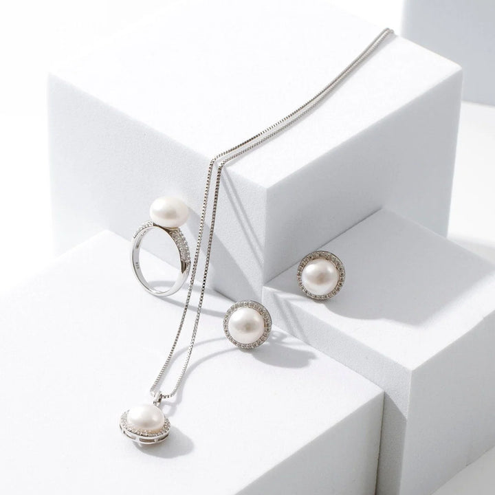 Introducing our Stella Earrings: exquisite white button freshwater pearls adorned with sparkling cubic zirconia&